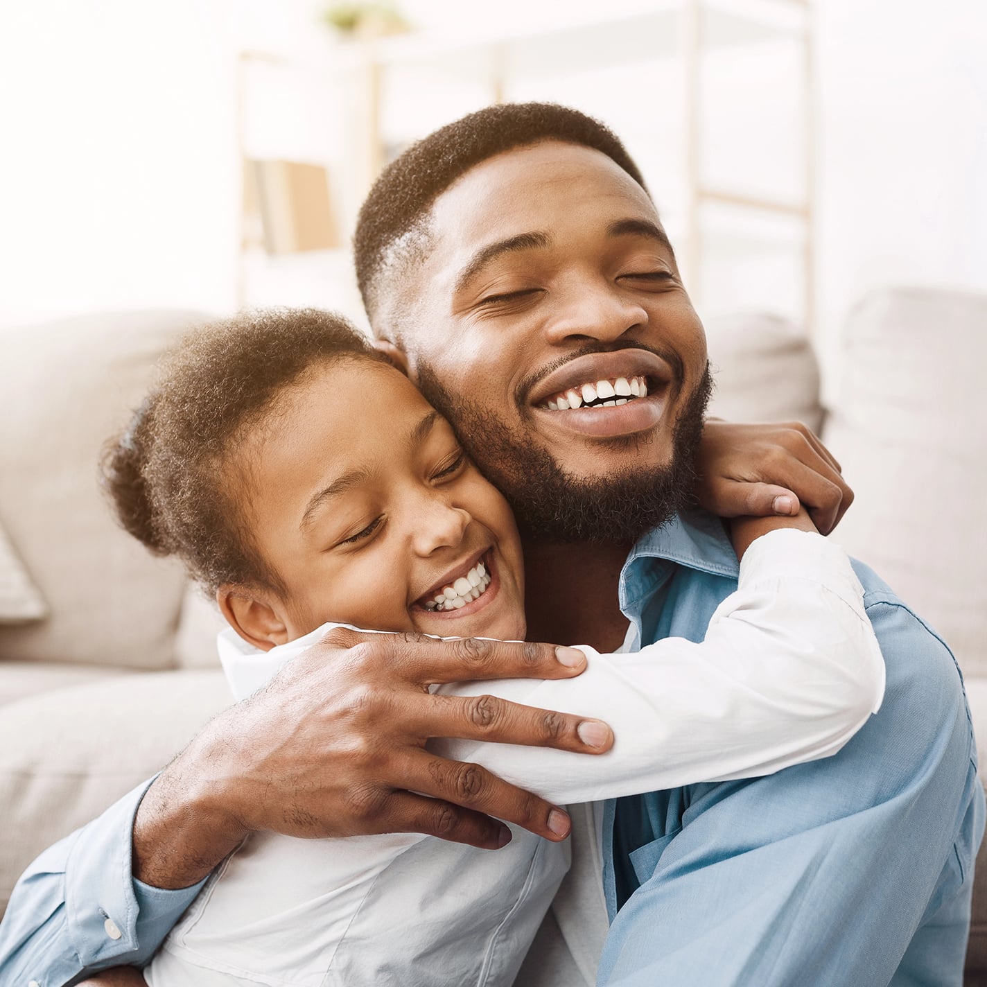 African-american daughter hugging father with love